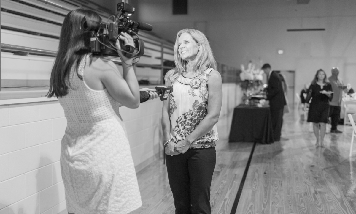 Jill Freeze being interviewed with camera and microphone